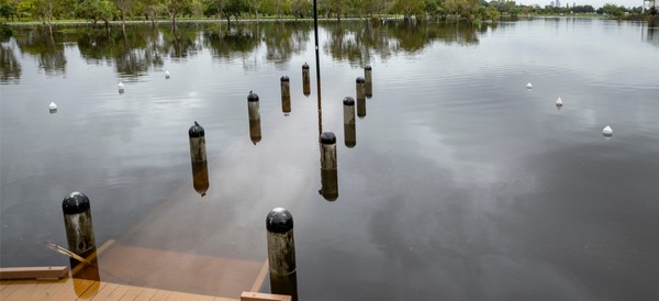 a dock on a lake completely flooded after a heavy rain