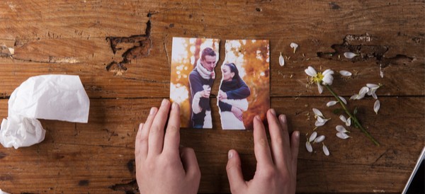 a picture of a couple that has been torn down the center
