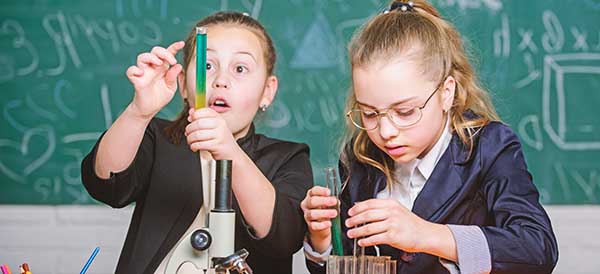 two young girls interested in science test a hypothesis