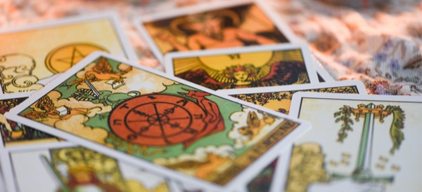 several tarot cards strewn across a tabletop
