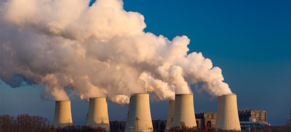 smoke pouring out of large stacks