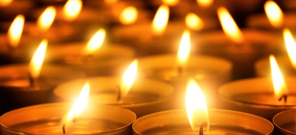 tealight candles burning together in a dark room