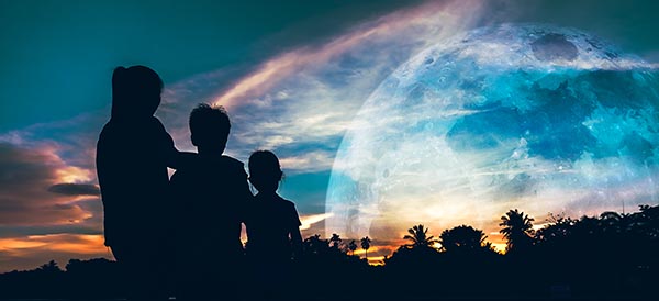 a family looks at a supermoon together