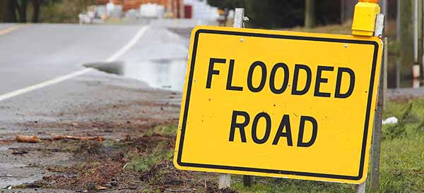 a flash flood sign on a flooded road