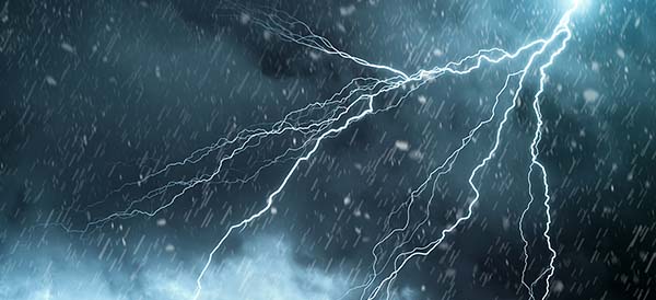 lightning against a blue cloudy sky